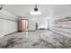 Large garage featuring ample storage space and access door to the house at 3808 Hollow Wood Dr, Valrico, FL 33594