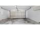 Spacious garage with concrete flooring and a large garage door at 3808 Hollow Wood Dr, Valrico, FL 33594