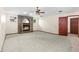 Spacious living room with a brick fireplace, carpet flooring and ceiling fan at 3808 Hollow Wood Dr, Valrico, FL 33594