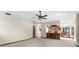 Open living room with neutral walls, bar seating looking into kitchen, and large carpeted space at 3808 Hollow Wood Dr, Valrico, FL 33594
