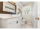 Bright bathroom featuring a modern vanity with stylish mirror and a shower with patterned curtain at 408 Pineapple St, Tarpon Springs, FL 34689