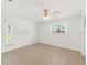 Bright bedroom featuring tile floors, white walls, a ceiling fan and view to the outside at 408 Pineapple St, Tarpon Springs, FL 34689