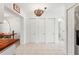 Hallway with a decorative ceiling light fixture and a row of white closet doors at 408 Pineapple St, Tarpon Springs, FL 34689