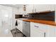 Modern kitchen with butcher block countertops, white cabinets, and stainless steel appliances at 408 Pineapple St, Tarpon Springs, FL 34689