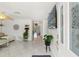 Bright living room featuring tile flooring, a ceiling fan and a large window with natural light at 408 Pineapple St, Tarpon Springs, FL 34689