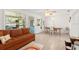 Comfortable living room features an adjacent dining area, tile floors, and outdoor access at 408 Pineapple St, Tarpon Springs, FL 34689