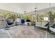 Screened patio featuring seating, hanging chairs, and view to backyard at 408 Pineapple St, Tarpon Springs, FL 34689