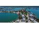 Scenic aerial view of waterfront homes with docks and boats on canals near a tranquil bay area at 412 20Th Ave, Indian Rocks Beach, FL 33785