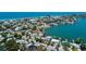 An aerial view reveals stunning waterfront homes with boat docks and lush landscaping on the canals at 412 20Th Ave, Indian Rocks Beach, FL 33785