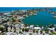A wide canal filled with boats is featured along with waterfront homes in this neighborhood aerial at 412 20Th Ave, Indian Rocks Beach, FL 33785