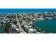 An aerial view shows a beautiful coastal neighborhood with canals, docks, and waterfront homes at 412 20Th Ave, Indian Rocks Beach, FL 33785