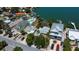 Waterfront homes feature boat docks and canals with clear blue water in this sunny aerial view at 412 20Th Ave, Indian Rocks Beach, FL 33785