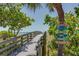 Boardwalk access to the beach with signage advocating for environmental responsibility at 412 20Th Ave, Indian Rocks Beach, FL 33785