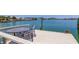 The waterfront dock features a charming table and chairs, perfect for relaxing by the water at 412 20Th Ave, Indian Rocks Beach, FL 33785