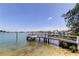 Beautiful waterfront view of a dock with a boat lift and space for seating in the distance at 412 20Th Ave, Indian Rocks Beach, FL 33785