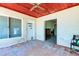 Sunroom featuring terracotta tile flooring, a wood ceiling, and water views from the window and a doorway at 412 20Th Ave, Indian Rocks Beach, FL 33785