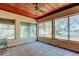 Bright sunroom with tile flooring, wood-paneled ceiling, and multiple windows with a scenic view of the water at 412 20Th Ave, Indian Rocks Beach, FL 33785