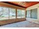 Cozy sunroom featuring terracotta tile, a wood ceiling with fan, and picture windows offering waterfront scenery at 412 20Th Ave, Indian Rocks Beach, FL 33785