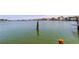 This waterfront view captures a serene, calm body of water with wooden posts in view at 412 20Th Ave, Indian Rocks Beach, FL 33785