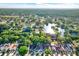Aerial view of residential neighborhood with mature trees, pond and manicured lawns at 4326 Venice Dr, Land O Lakes, FL 34639