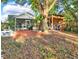 Private backyard featuring screened in patio, built in seating, dining area, and mature trees at 4326 Venice Dr, Land O Lakes, FL 34639