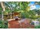 Cozy backyard with seating area, fire pit, mature trees and well maintained landscaping at 4326 Venice Dr, Land O Lakes, FL 34639