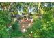 Secluded backyard featuring large trees, fenced yard, covered patio, and storage shed at 4326 Venice Dr, Land O Lakes, FL 34639