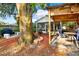 Outdoor living space featuring a covered patio area, built-in seating, and mature trees at 4326 Venice Dr, Land O Lakes, FL 34639