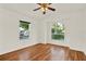 Bright bedroom with beautiful hardwood floors, arched window, and vaulted ceiling with ceiling fan at 4326 Venice Dr, Land O Lakes, FL 34639