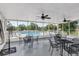 Screened patio with multiple tables and seating, offering an outdoor view of the community pool at 4326 Venice Dr, Land O Lakes, FL 34639