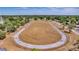 Aerial view of a tree-lined running track with green space in the middle surrounded by a small neighborhood at 4326 Venice Dr, Land O Lakes, FL 34639