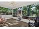 View from screened patio of backyard with fire pit and outdoor seating area at 4326 Venice Dr, Land O Lakes, FL 34639