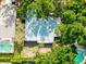 Aerial view of the home and backyard, featuring mature trees and a pool nearby at 4442 Summer Oak Dr, Tampa, FL 33618