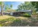 A spacious backyard featuring a partially covered patio and mature trees at 4442 Summer Oak Dr, Tampa, FL 33618