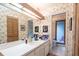 Floral bathroom featuring a white vanity, mirror, and a view into a shower room at 4442 Summer Oak Dr, Tampa, FL 33618
