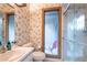 Cozy bathroom showcasing a toilet and glass enclosed shower with marble-patterned surround at 4442 Summer Oak Dr, Tampa, FL 33618