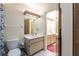 Bathroom with double vanities, a toilet and shower, and a set of wooden folding doors at 4442 Summer Oak Dr, Tampa, FL 33618