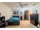 Bedroom featuring a ceiling fan, platform bed with blue cover, anime wall art, and dark wood furnishings at 4442 Summer Oak Dr, Tampa, FL 33618