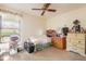 Bedroom with a ceiling fan, floral window treatment and an assortment of furniture at 4442 Summer Oak Dr, Tampa, FL 33618