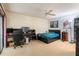 Spacious bedroom with neutral carpet, ceiling fan, walk-in closet and sliding glass door to the outside patio at 4442 Summer Oak Dr, Tampa, FL 33618