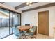 Bright dining area with white tiled floors, exposed ceiling beams, and sliding glass doors to the outside patio at 4442 Summer Oak Dr, Tampa, FL 33618
