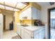 The bright kitchen features white cabinets, laminate countertops and a breakfast bar with seating at 4442 Summer Oak Dr, Tampa, FL 33618