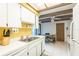 The bright kitchen features white cabinets, laminate countertops and a yellow accent wall at 4442 Summer Oak Dr, Tampa, FL 33618