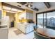 Bright kitchen with white cabinets, tiled floor, exposed ceiling beams, and a sliding glass door to the patio at 4442 Summer Oak Dr, Tampa, FL 33618