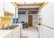 Bright kitchen featuring white appliances, white cabinets, laminate countertops and a yellow accent wall at 4442 Summer Oak Dr, Tampa, FL 33618