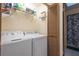 Laundry area equipped with a side by side washer and dryer, and overhead storage shelves at 4442 Summer Oak Dr, Tampa, FL 33618