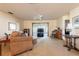 A cozy living room with comfortable seating, a ceiling fan, and a sliding door leading to the outdoors at 4442 Summer Oak Dr, Tampa, FL 33618