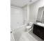 The bathroom features a shower/tub combo and a dark wood vanity at 4461 Globe Thistle Dr, Tampa, FL 33619