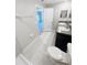 Bathroom with double sinks, tiled floors, and a separate shower and toilet area at 4461 Globe Thistle Dr, Tampa, FL 33619