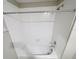 White tiled bathtub with shower head and stainless steel fixtures at 4461 Globe Thistle Dr, Tampa, FL 33619